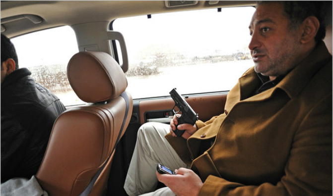Namir al-Akabi, the C.E.O. of Almco, packs a pistol and a cellphone